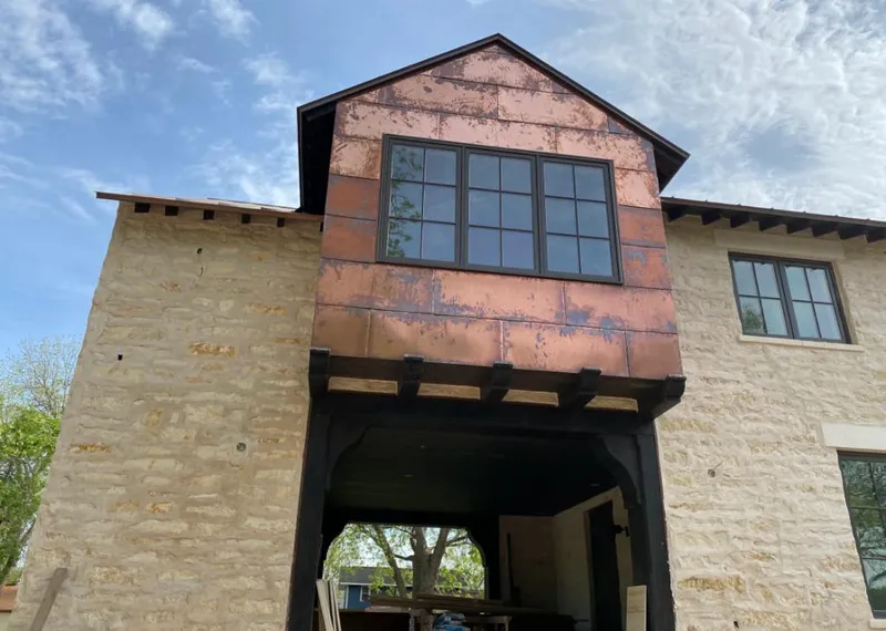 Copper metal panel facade on a stone building for Metal Roof Coating in Kendall