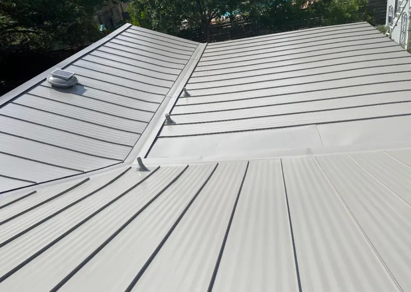 Solar attic fan installed on a metal roof for Roof Ventilation in Kendall